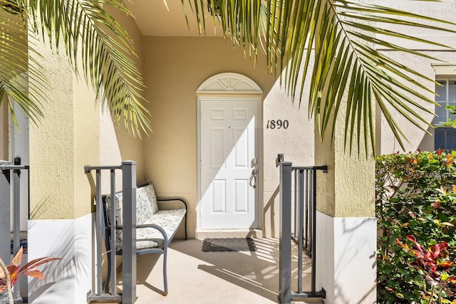 entrance to property featuring stucco siding