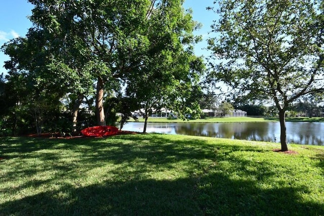 exterior space featuring a yard and a water view