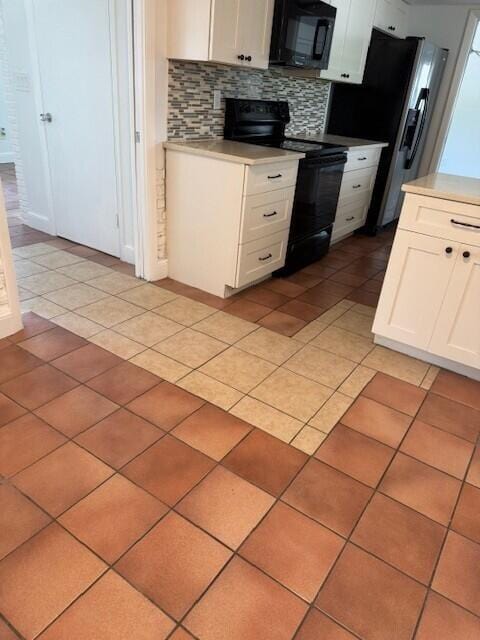 kitchen featuring light tile patterned floors, decorative backsplash, black appliances, white cabinets, and light countertops