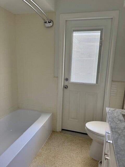 bathroom with vanity, toilet, and speckled floor