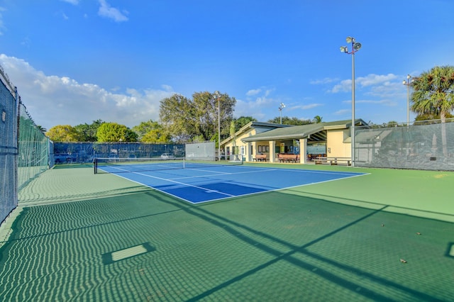 view of tennis court featuring fence