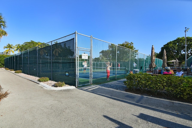 view of sport court with a gate and fence