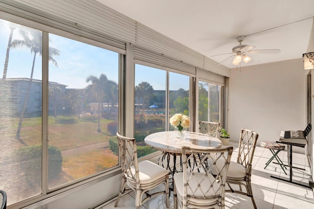 sunroom featuring a ceiling fan