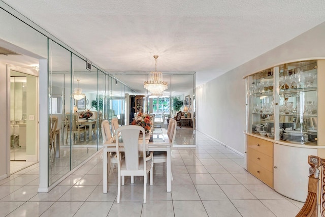 dining room featuring light tile patterned floors, a chandelier, a textured ceiling, and visible vents