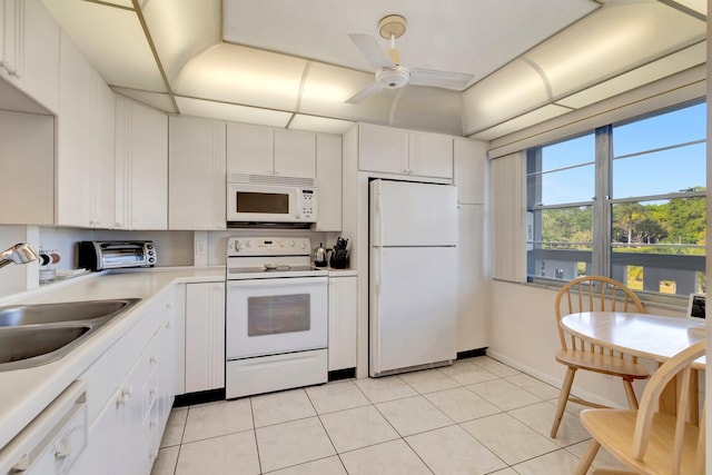 kitchen featuring a sink, white appliances, white cabinetry, and light countertops