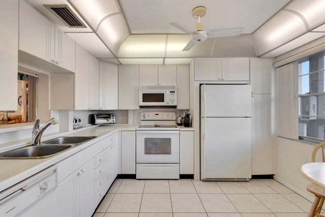 kitchen with white appliances, visible vents, a sink, light countertops, and white cabinetry