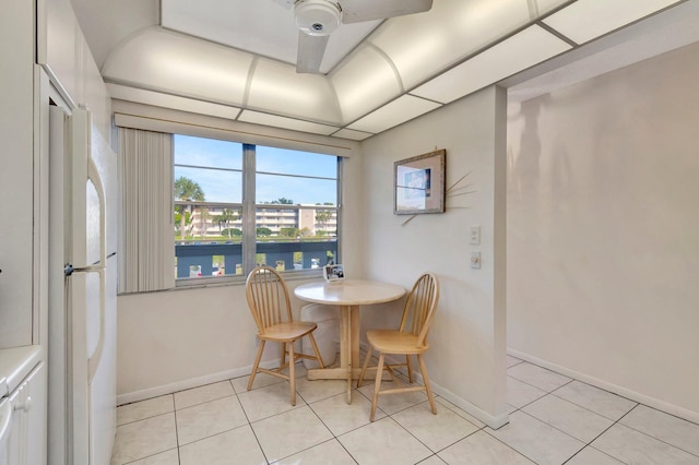 dining space featuring light tile patterned floors and baseboards