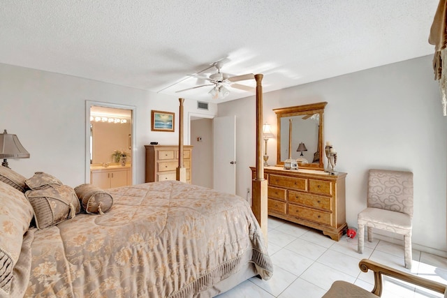 bedroom with visible vents, a ceiling fan, a textured ceiling, connected bathroom, and light tile patterned floors