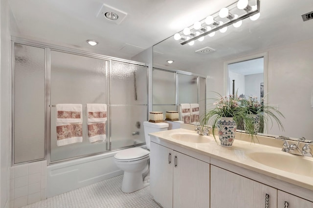 full bath featuring tile patterned flooring, double vanity, combined bath / shower with glass door, and a sink