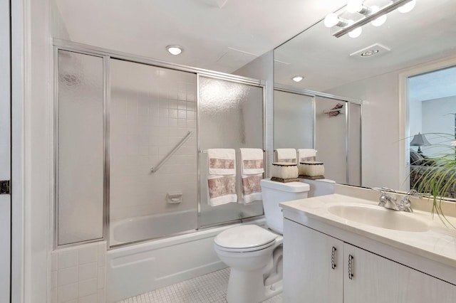 full bathroom featuring tile patterned floors, toilet, vanity, and shower / bath combination with glass door