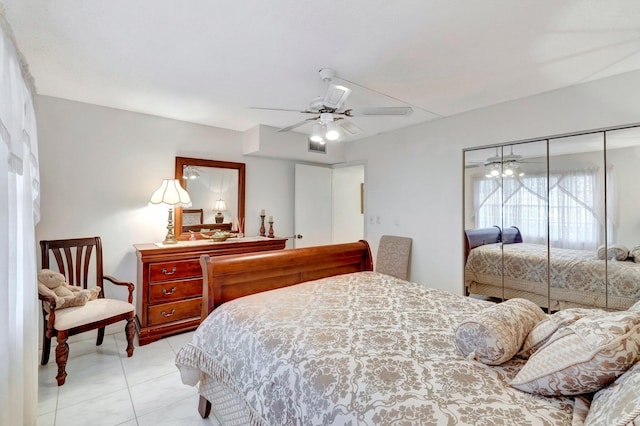 bedroom with light tile patterned floors, a closet, and a ceiling fan