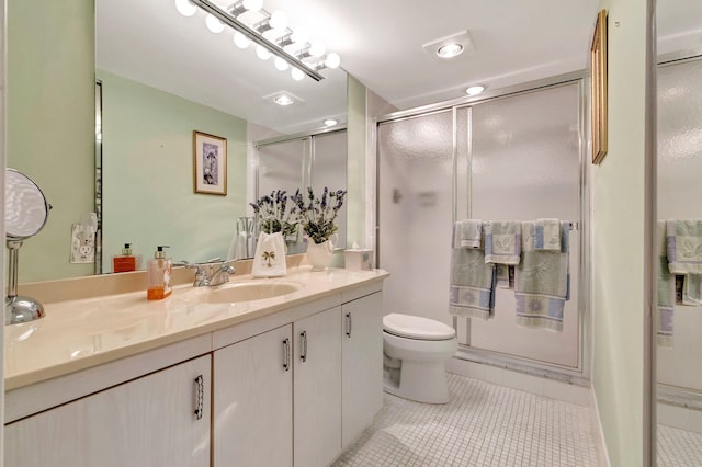 bathroom with toilet, recessed lighting, a stall shower, tile patterned floors, and vanity