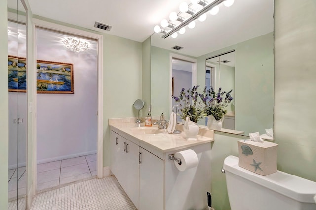 bathroom with tile patterned flooring, toilet, vanity, and visible vents