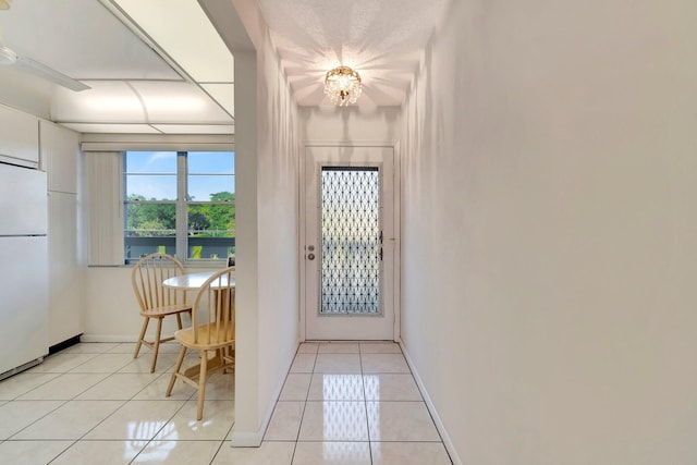 2901 Victoria Cir Unit F2, Coconut Creek, FL 33066 - entryway featuring light tile patterned floors, a chandelier, and baseboards