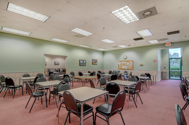 dining space with visible vents, a paneled ceiling, carpet floors, and wainscoting