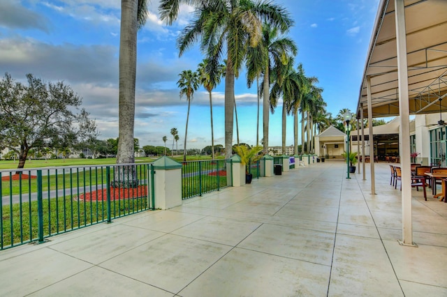 surrounding community with a lawn and fence