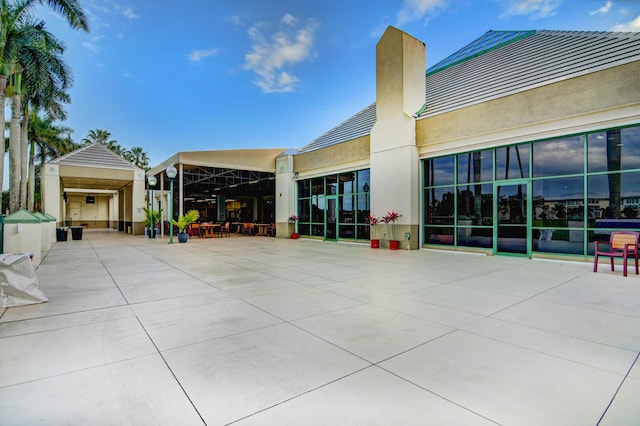 exterior space featuring stucco siding and a chimney