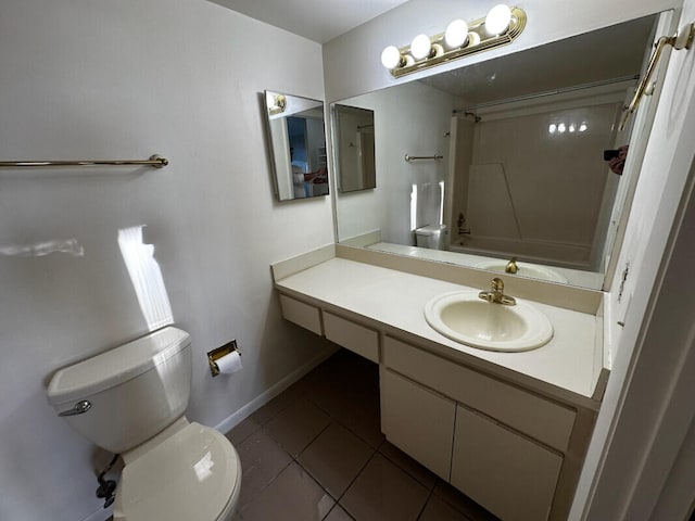 bathroom featuring tile patterned floors, toilet, baseboards, bathing tub / shower combination, and vanity