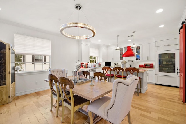 dining room with light wood-style flooring, recessed lighting, baseboards, and ornamental molding