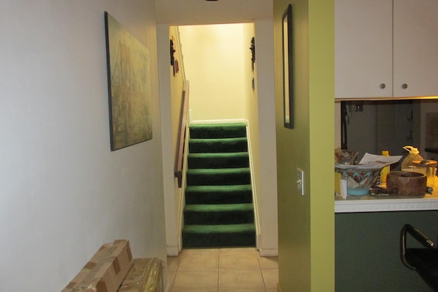 hallway with stairway and light tile patterned flooring