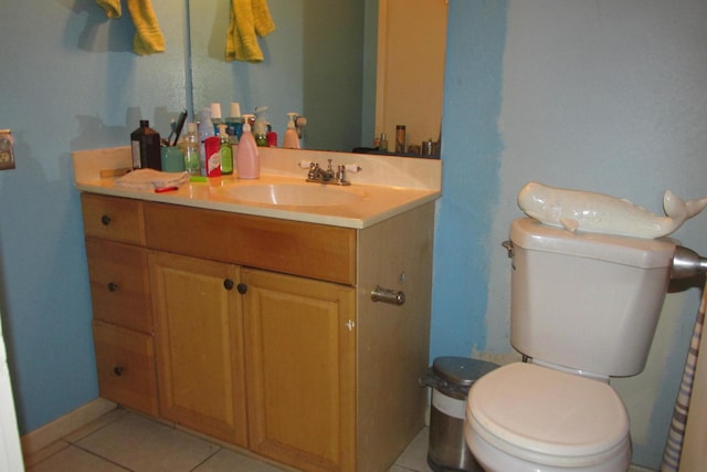 bathroom featuring tile patterned flooring, toilet, and vanity