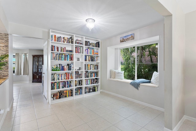 living area with tile patterned floors and baseboards