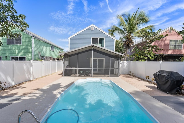 back of property with a fenced in pool, a patio, a fenced backyard, and a sunroom