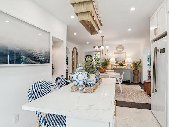 dining space featuring recessed lighting, arched walkways, and an inviting chandelier