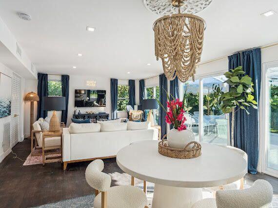 dining area with a notable chandelier, wood finished floors, recessed lighting, and a wealth of natural light