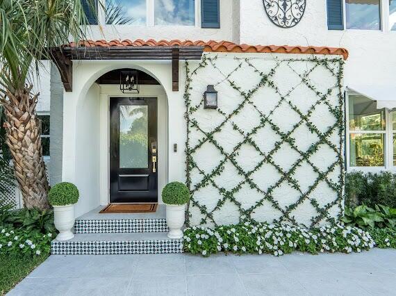 doorway to property with stucco siding and a tile roof