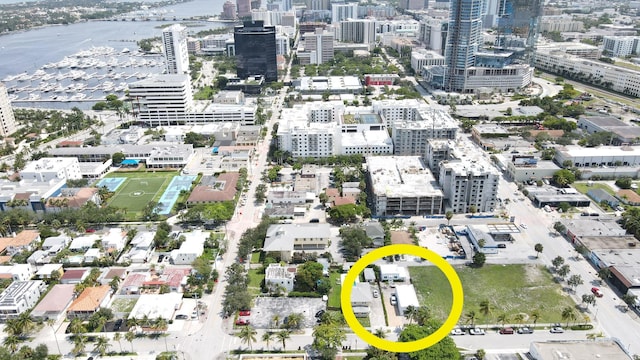 birds eye view of property featuring a water view and a view of city