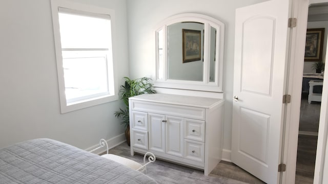 bedroom featuring baseboards and light wood-style floors