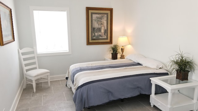 bedroom featuring tile patterned floors and baseboards