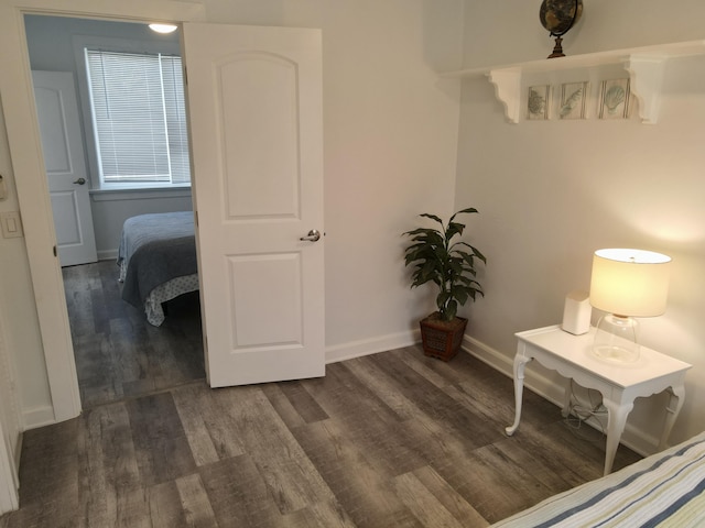 bedroom featuring baseboards and wood finished floors