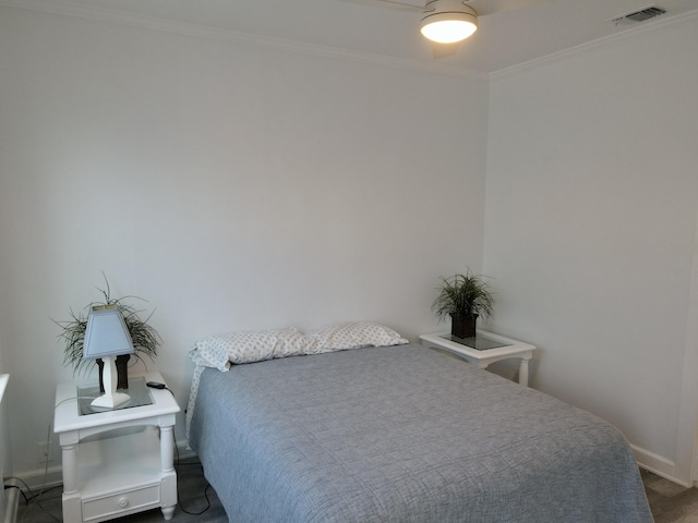 bedroom with visible vents, baseboards, and ornamental molding