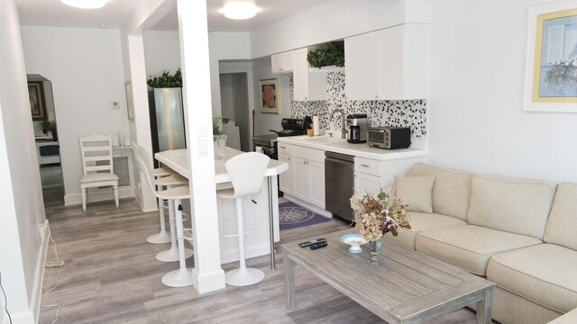 living area featuring a toaster and light wood-style flooring