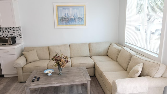 living room with a toaster and light wood-style flooring