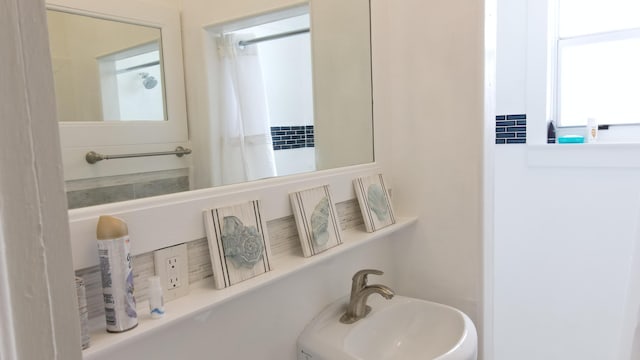 bathroom featuring a shower with curtain and a sink