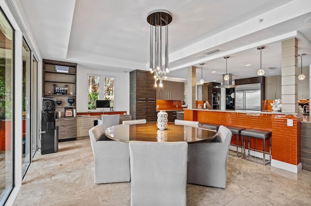 dining room with visible vents and a tray ceiling