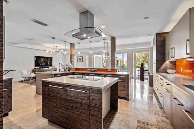 kitchen with visible vents, modern cabinets, black electric cooktop, and island range hood