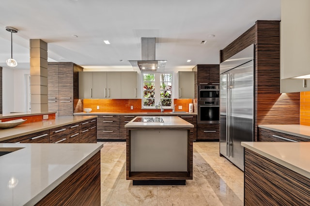 kitchen featuring tasteful backsplash, a kitchen island, light countertops, appliances with stainless steel finishes, and modern cabinets