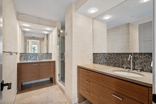 bathroom featuring a stall shower, tile walls, and a sink