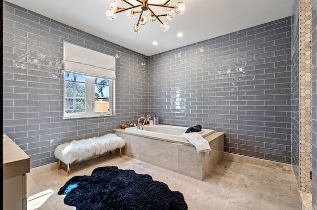 bathroom featuring a notable chandelier, tile walls, and a bath