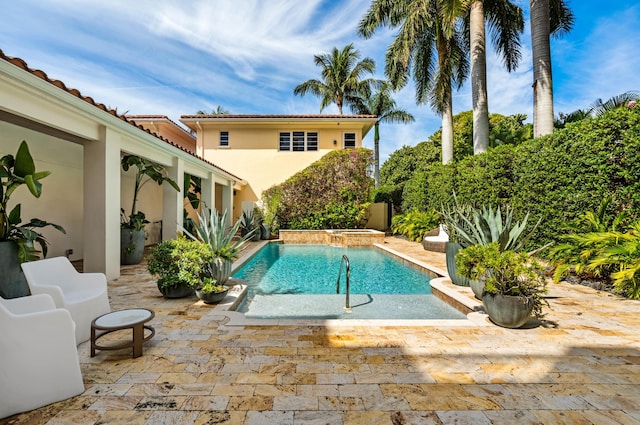 view of pool featuring a patio and a pool with connected hot tub