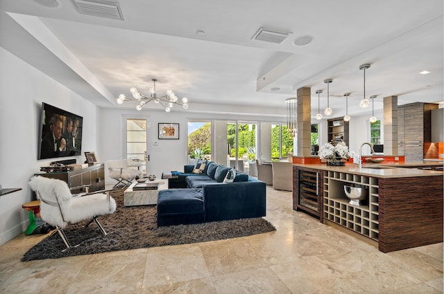 living area featuring visible vents, baseboards, and an inviting chandelier