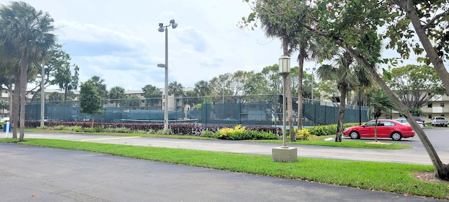 view of tennis court featuring fence