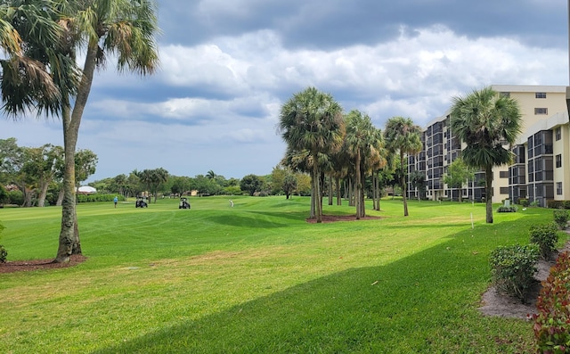 view of property's community with a lawn