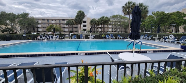 pool featuring a patio and fence