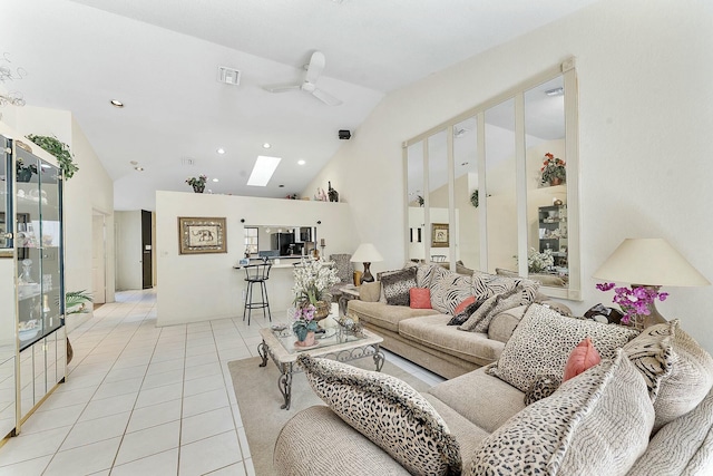 living room featuring visible vents, light tile patterned floors, vaulted ceiling with skylight, recessed lighting, and a ceiling fan