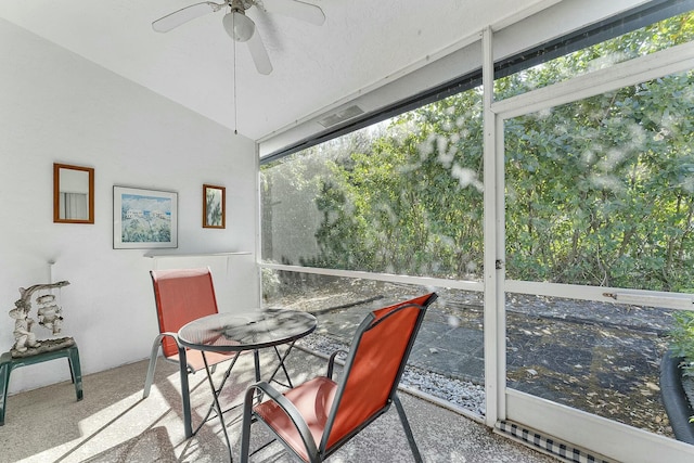 sunroom featuring lofted ceiling and ceiling fan